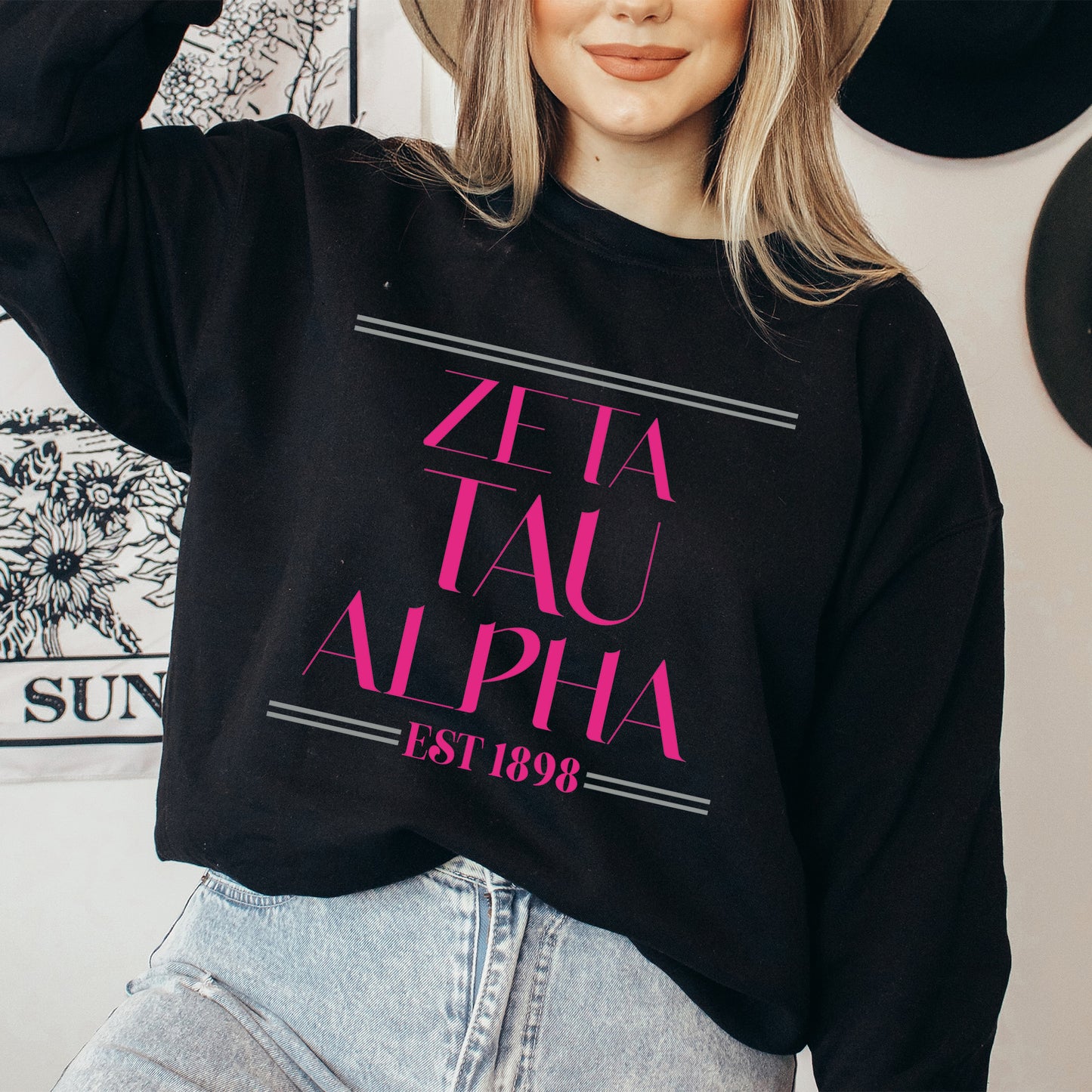 a woman wearing a hat and a black sweatshirt