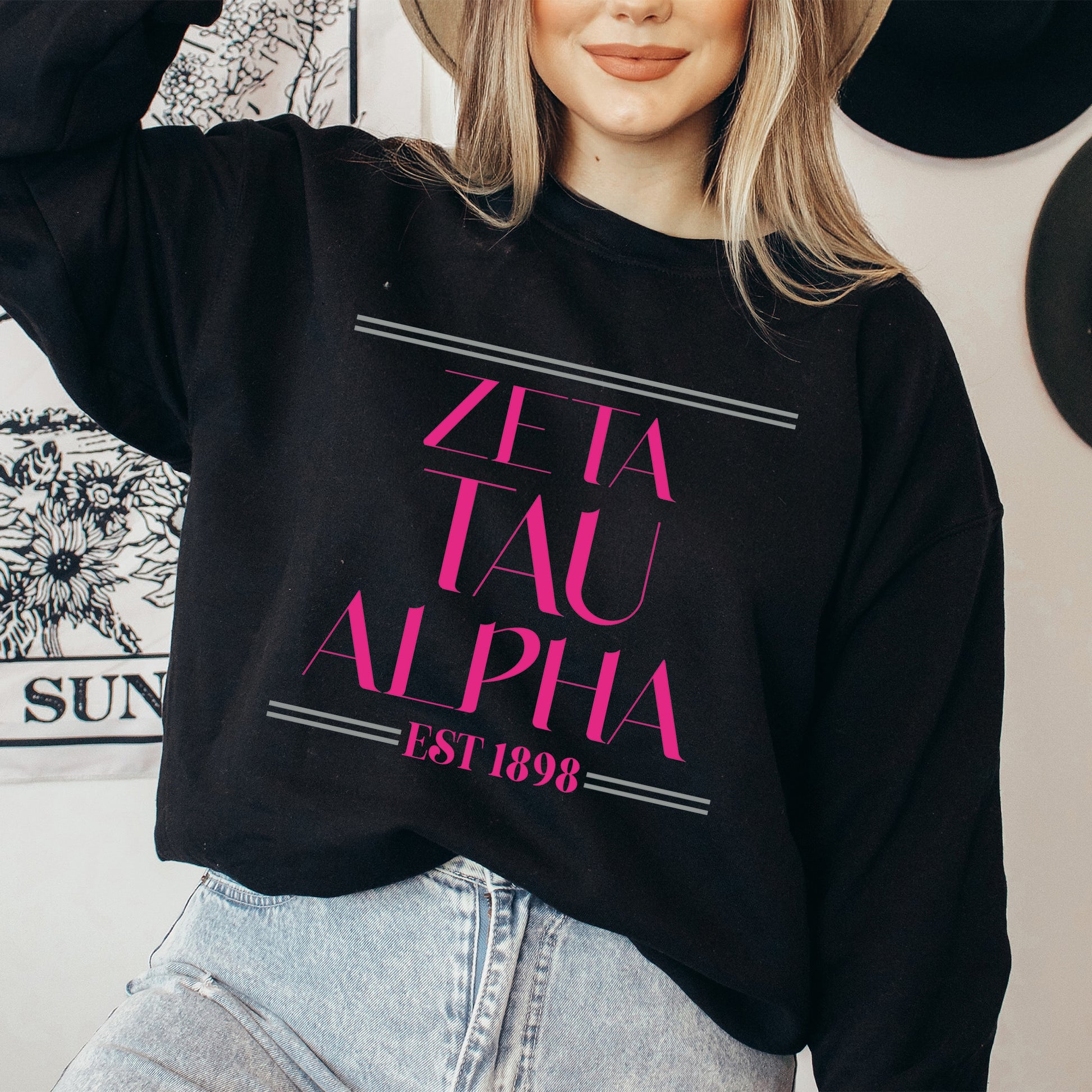a woman wearing a hat and a black sweatshirt