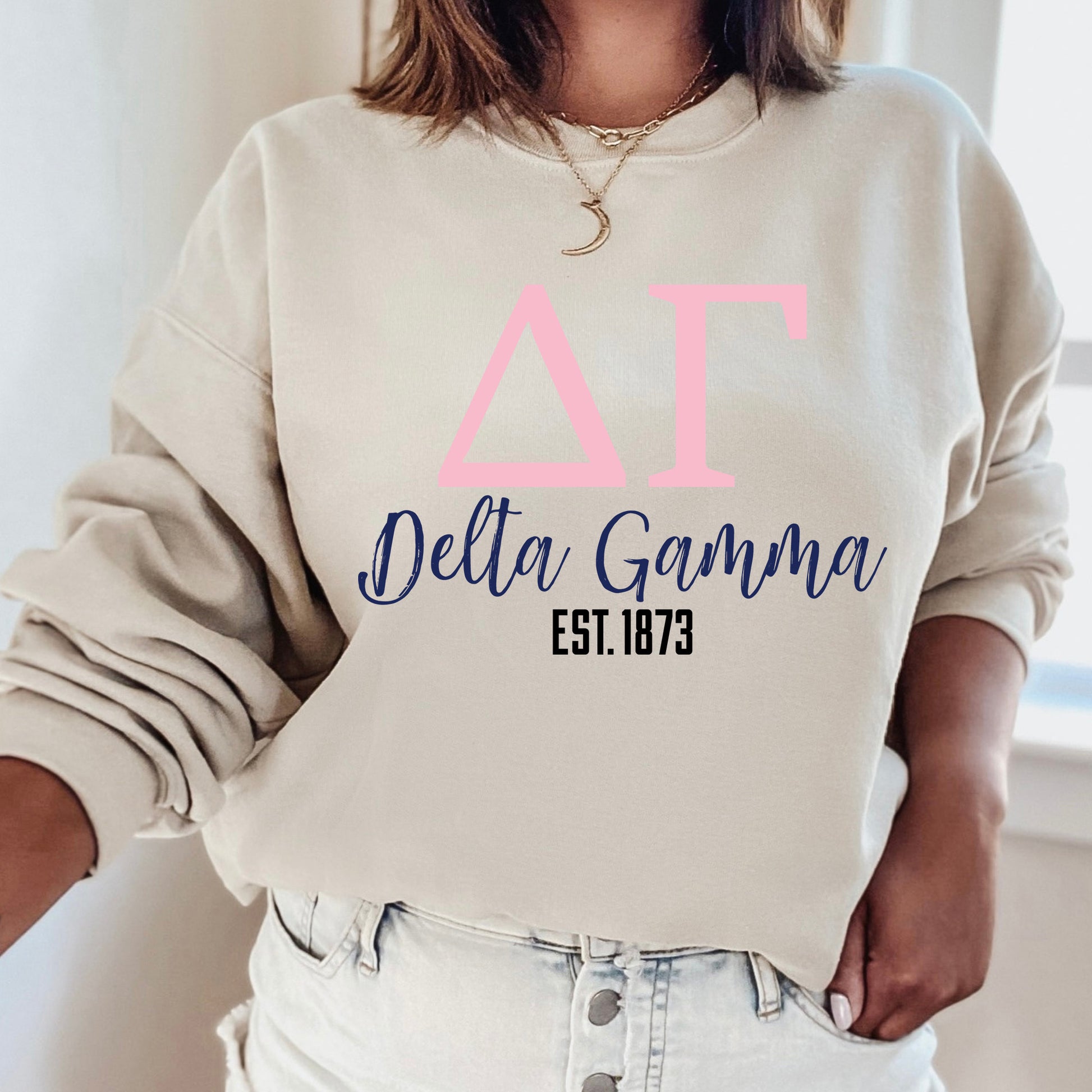 a woman wearing a sweatshirt that says delta gamma